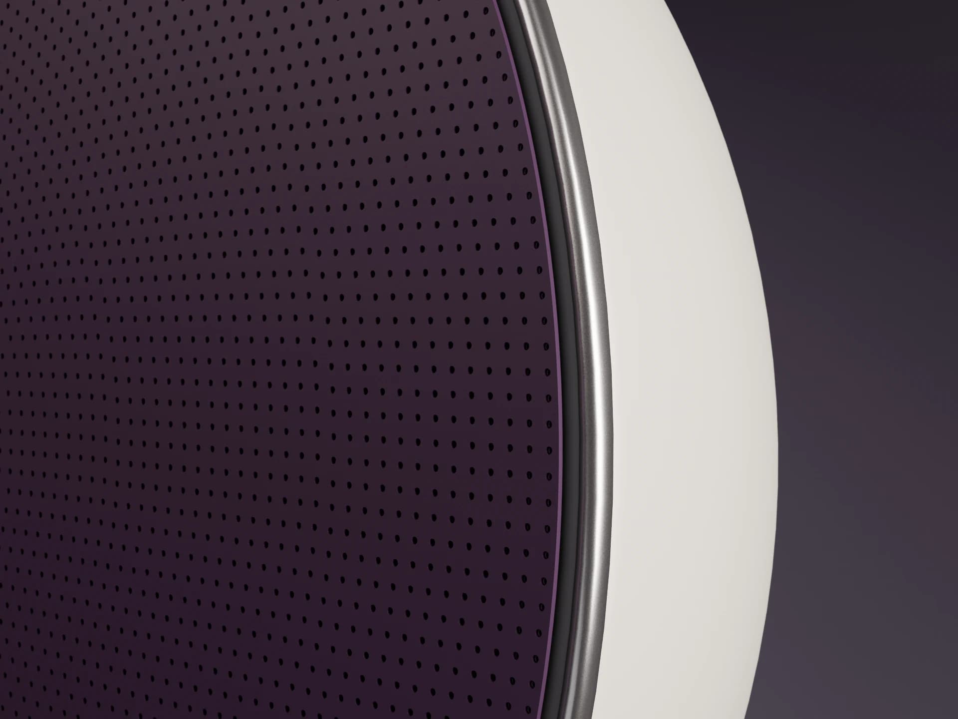 Orbit's aubergine perforated face meeting its silver rim and curved chalk shell
